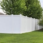 Contemporary white vinyl fence surrounding yard