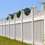 White vinyl fence with contemporary look surrounding a homes backyard